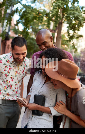 Eine Gruppe von Freunden in Stadt in Foto Suchen auf Handy Stockfoto