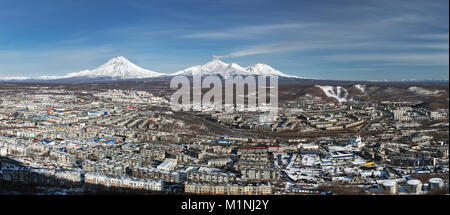 Winterliche Panorama der Blick von oben auf die urbane Landschaft Wohngebäude von Petropawlowsk-kamtschatski Stadt und Landschaft Vulkane der Halbinsel Kamtschatka Stockfoto