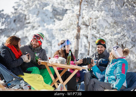 Skifahrer Gruppe erfrischend mit Drink nach dem Skifahren im Cafe im Gelände Stockfoto