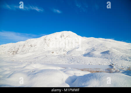 Blick in Richtung der Corbett Ben Vrackie über den zugefrorenen See a' choire in der Nähe von Pitlochry Perthshire Schottland Stockfoto