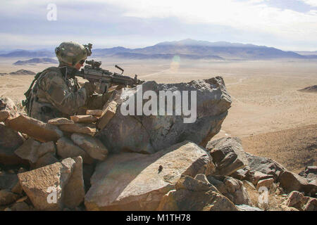 Ein Soldat der US-Armee in den zweiten Bataillon zugeordnet, 23 Infanterie Regiment, 1 Stryker Brigade Combat Team, 4 Infanterie Division, Scans für simulierte Feinde Während entscheidende Maßnahmen Rotation 18-03 am National Training Center in Fort Irwin, Calif., Jan. 16, 2018. (U.S. Armee Stockfoto