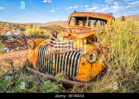 Alten rostigen Abschleppwagen an den Colorado Ausläufern von Büschen überwuchert Stockfoto