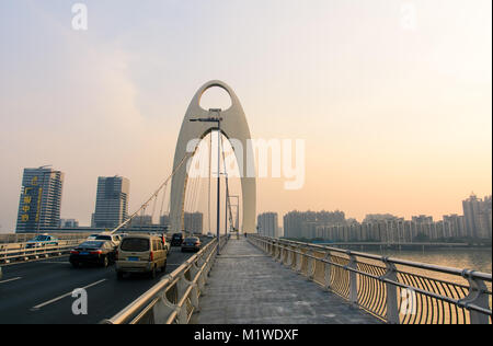 GUANGZHOU, China - 3. JANUAR 2018: Guangzhou Liede Brücke über Perl Fluss mit Autos und Fußgänger Titel bei Sonnenuntergang Stockfoto