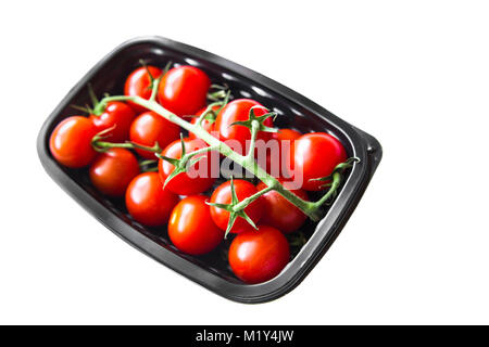 Kirschtomaten in Kunststoffbehälter gegen einen weißen Hintergrund Reif Stockfoto