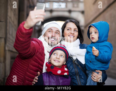 Positive Familie von vier Tun selfie in Stadt in Winter Tag Stockfoto