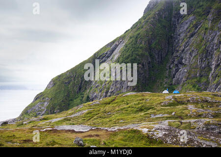 Zwei blaue Zelte auf grünem Gras in der Nähe von einem See. Stockfoto