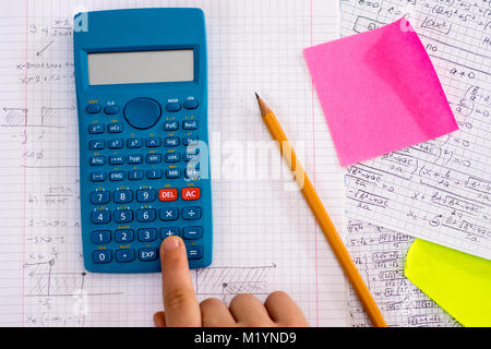 Mit dem Finger auf dem Rechner Taste Während der Mathematischen Lektion. Schule Konzept. Stockfoto