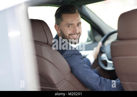 Unternehmer sitzen am Steuer eines Autos, und wenn man die Kamera Stockfoto