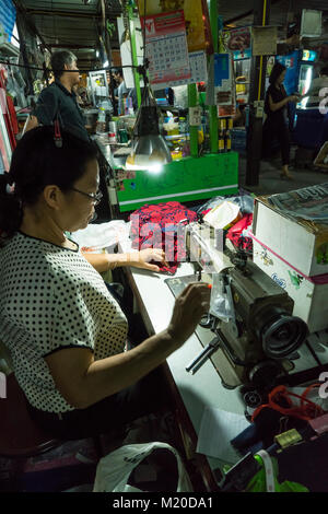 Eine Frau ein Kleid zu nähen in Bangkok, Thailand Stockfoto