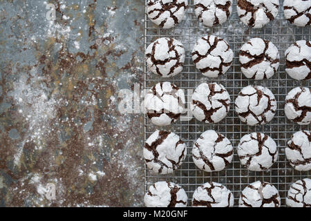 Hausgemachte Schokolade Crinkle Cookies auf eine Kühlung Rack auf schiefer Hintergrund Stockfoto