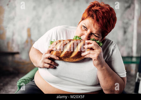 Fette Frau isst Sandwich, Übergewicht, bulimic. Ungesunde Lebensweise. Fettleibigkeit Stockfoto