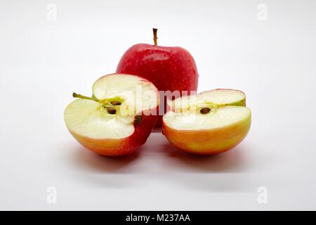Zwei Jazz Apple mit einem in der Hälfte auf weißem Hintergrund in Scheiben geschnitten Stockfoto