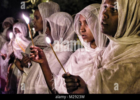 Januar 19, 2018 - Gondar, Amhara Region, Äthiopien - Pilger beten bei Kerzenschein.. Die jährlichen Timkat Festival, eine orthodoxe christliche Fest der Epiphanie, erinnert sich an die Taufe Jesu im Jordan. Während des Festivals, tabots, Modelle der Lade des Bundes, werden von Kirchen rund um die Stadt Gondar und zogen durch die Straßen zu Fasilides Badewanne. Wo schließlich die Pilger am Ende das Baden im Wasser durch die Priester gesegnet. (Bild: © Oscar Espinosa/SOPA über ZUMA Draht) Stockfoto