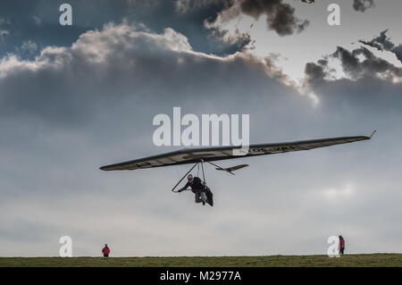 Firle Beacon. East Sussex. Februar 2018. Wetter in Großbritannien. Hardy erfahrene Hansegler-Piloten nutzen den kalt vorherrschenden Nordwind über die South Downs in der glorreichen Landschaft von Sussex. Stockfoto