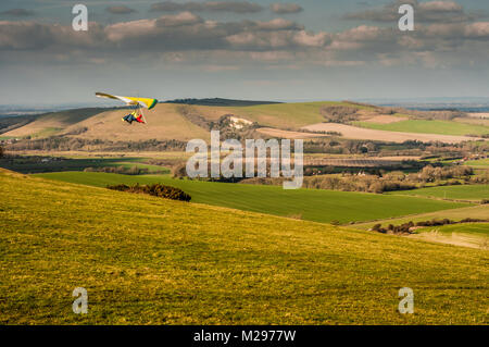 Firle Beacon. East Sussex. Februar 2018. Wetter in Großbritannien. Hardy erfahrene Hansegler-Piloten nutzen den kalt vorherrschenden Nordwind über die South Downs in der glorreichen Landschaft von Sussex. Stockfoto