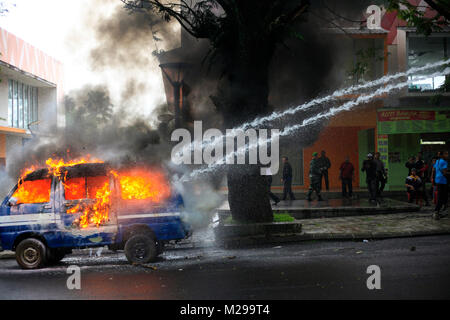 Bogor, West Java, Indonesien, 3. Februar 2018. Polizisten löschten die Feuer auf ein Auto, das durch Demonstranten während einer Simulation der Sicherheit der lokalen Wahlen, Bogor, West Java, Indonesien, 3. Februar 2018 verbrannt wurde Stockfoto