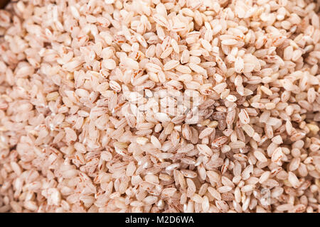 Raw rosa Reis closeup, Hintergrund. Zutaten für eine gesunde Ernährung. Stockfoto