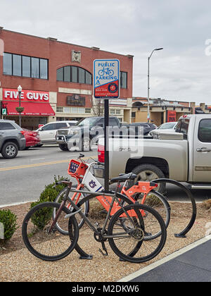 Öffentlicher Parkplatz für Fahrräder Ständer mit zwei Fahrräder geparkt wird, ist eine Fahrt mit dem Fahrrad von Teilen der Auburn Universität, als bike Hub in Auburn, Alabama USA bekannt. Stockfoto