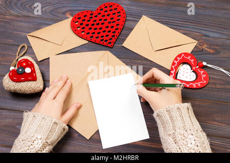 Kraftpapier Umschlag mit roten Herzen auf Holztisch mit kopieren. Stockfoto