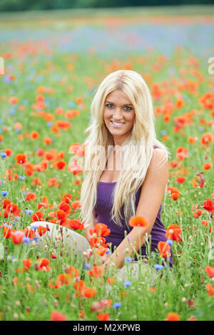 Frau, Sitzen, Jung, blond, Mohn, in die Kamera schauen, lächeln Stockfoto