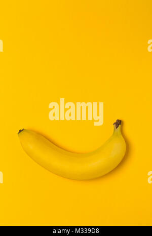 Single Frische, gelbe, reife Banane auf gelbem Hintergrund Stockfoto