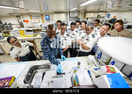 SUBIC BAY, Philippinen (Aug. 10, 2015) Hospital Corpsman 1. Klasse Emmanual Aligwekwe, zugeordnet zu den Hospital Ship USNS Mercy (T-AH 19), zeigt die Laborarbeit nach Brig. Gen. Joselito Payumo Avancena, die Streitkräfte der Philippinen Surgeon General, während der Pacific Partnerschaft 2015. Barmherzigkeit ist derzeit in den Philippinen für seine dritte Mission Hafen von PP15. Pazifische Partnerschaft ist in seinen 10 Iteration und ist die größte jährliche multilaterale humanitäre Hilfe und Katastrophenhilfe Abwehrbereitschaft mission in der Indo-Asia durchgeführt - Pazifik Region. Bei der Ausbildung für Krise Bedingungen, Stockfoto