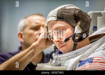 Canadian Space Agency astronaut David Saint Jacques hilft Astronaut Oberst Tyler N. 'Nick' Haag bereiten in einen Pool mit einem Modell der Internationalen Raumstation (ISS) für Extra Vehicular Activity (EVA) Ausbildung bei Neutralstellung des Johnson Space Flight Center Buoyancy Laboratory (NBL) in Houston, Tex, April 27, 2017 gesenkt werden. Während der Ausbildung bei der NBG, Haag einen Raumanzug trägt, die in der Nähe von Schwerelosigkeit er Begegnung wird während der Durchführung von EVAs, oder außenbordeinsätze zu simulieren, während sie als Flugingenieur an Bord der ISS-Expedition 54/55 in 2018-2019. (U.S. Air Force Foto von J.M. Eddins Jr Stockfoto