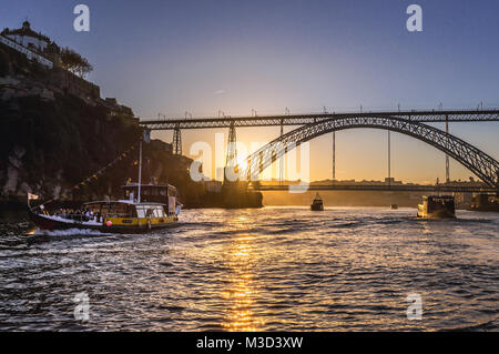 Ausflugsboote und Dom Luis I Brücke über den Fluss Douro zwischen Porto und Vila Nova de Gaia Städte in Portugal. Serra do Pilar Kloster auf der linken Seite Stockfoto