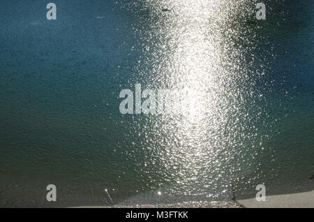 Detail des Sonnenlichts Reflexion in gefrorenem Wasser im Winter Tag, eisige Textur und Glanz Hintergrund Stockfoto