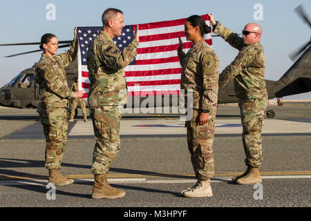 Major General Steven W. Ainsworth, Kommandierender General, 377 Theater Sustainment Command, verwaltet den Eid der Rekrutierung zu Sgt. Leverduque Vianca, 826Th Ordnance Company, verlängert ihr Engagement für die US Army Reserve, am Lager Buhering, Kuwait, Feb 4, 2018. Die Zeremonie fand während der Gemeinsamen monatlichen Zugang für Reserve Komponente (JMARC), vierteljährlich eine Chance für Führungskräfte aus der U.S. Army National Guard und Finden mit eingesetzten Soldaten zu besuchen. Die JMARC bot die Möglichkeit zu finden, die den Einsatz der Mission auf zukünftige Einheiten bereit sind, zu verstehen. Stockfoto