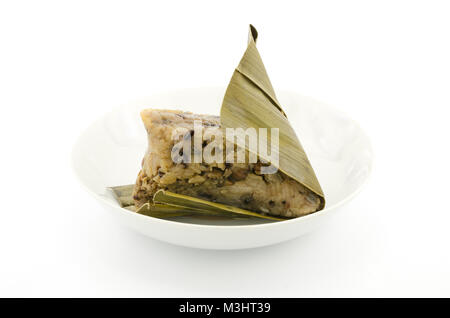 Traditionelle gewickelt Reis Knödel oder zongzi auf einem Teller, auf weißem Hintergrund Stockfoto