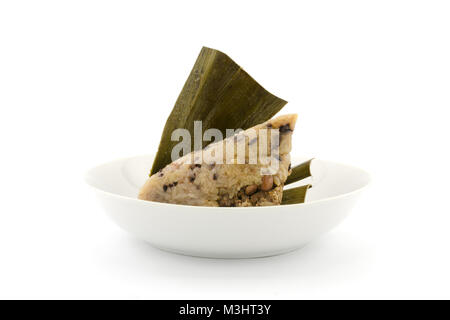 Traditionelle gewickelt Reis Knödel oder zongzi auf einem Teller, auf weißem Hintergrund Stockfoto