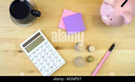 Moderne Büro Schreibtisch Overhead mit Rechner, Sparschwein und Cash und Overhead. Stockfoto