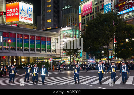 Die japanischen Polizisten, die die Massen von Menschen, die während der Halloween Feiern in Shibuya, Tokio Stockfoto