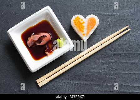 Sushi abstrakte Meeresfrüchte Herz Konzept auf schwarzem Marmor Menü Hintergrund Stockfoto