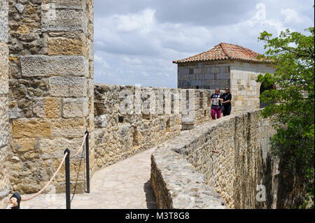Zwei junge Frauen, die entlang der Wand des Castelo de São Jorge, Lissabon, Portugal Stockfoto