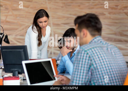 Angenehme junge lächelnde Kollegen diskutieren Projekt in modernen startup Office Stockfoto