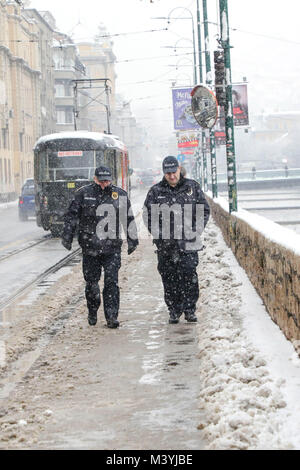 Sarajevo, Bosnien und Herzegowina. 13 Feb, 2018. Polizisten zu Fuß im Schnee in Sarajewo, Bosnien und Herzegowina, am 13.02.2018. Schneefall schlagen Sarajevo hier am Dienstag. Credit: Haris Memija/Xinhua/Alamy leben Nachrichten Stockfoto