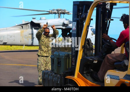 150806-A-ZA 034-040 ROSEAU, Dominica (Aug. 6, 2015) Chief's Bootsmann Mate Deon Bailey, zur Marine Cargo Handling Bataillon 1 Yorktown, Virginia. zugeordnet, leitet ein Gabelstapler am Dominica Flughafen zur Unterstützung der Fortsetzung Versprechen 2015. Weiterhin Versprechen ist ein US Southern Command - gefördert und U.S. Naval Forces Southern Command/USA 4. Flotte durchgeführte, Bereitstellung der zivil-militärischen Operationen einschließlich humanitärer - zivile Hilfe, Experte Börsen, Medizin, Zahnmedizin, Tiermedizin und Engineering Support und Disaster Response partner Nationen zu verhalten und die Unterstützung der USA und commitme zu zeigen Stockfoto