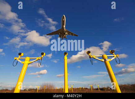 Ein Passagier Jet über Landebahn Ansatz Beleuchtung vor der Landung fliegen. Stockfoto