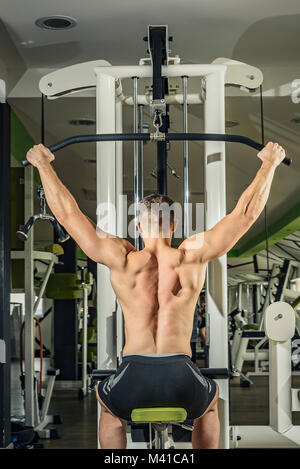 Schulter nach unten ziehen. Fitness Mann, Lat Pulldown Training im Fitnessstudio. Oberkörper Übung für den oberen Rücken. Stockfoto