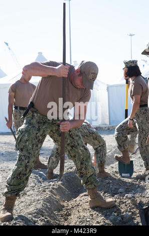 FUJAIRAH, Vereinigte Arabische Emirate (Jan. 13, 2018) U.S. Navy Sailors, zum Angriff Handwerk Einheit 1 zugewiesen, Gräben Stromleitungen während Native Fury 18 zu decken. Die Übung ist so konzipiert, Special Purpose Marine-Air - Masse Aufgabe Force-Native Fury Marines und US-Marine Seeleute in maritime Vorpositionierung kraft Operationen zu trainieren und zielt darauf ab, die Kenntnisse zu verbessern, erweitern die Zusammenarbeit im maritimen Fähigkeiten zu verbessern und die langfristige Stabilität in der Region und die Interoperabilität zwischen den Vereinigten Arabischen Emiraten und in den USA (U.S. Marine Foto von Mass Communication Specialist 1. Klasse Eric Chan/Rele Stockfoto