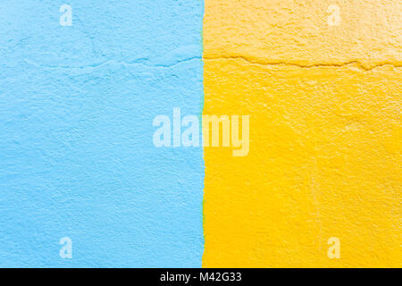 Stuck blaue und gelbe Wand Textur Hintergrund. Stockfoto