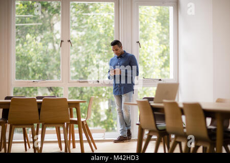 In der leeren Büro Geschäftsfrau am Smartphone suchen Stockfoto