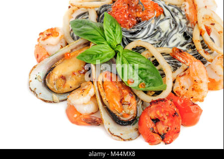Schwarze Nudeln mit Meeresfrüchten und Basilikum Stockfoto