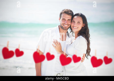 Zusammengesetztes Bild des glücklichen Paares Blick in die Kamera Stockfoto