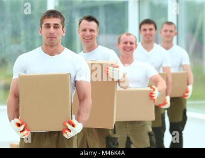Team von Bauherren mit Boxen von Baustoffen Stockfoto