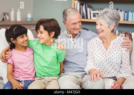 Glücklich Enkel mit Großeltern zu Hause auf sofa Stockfoto