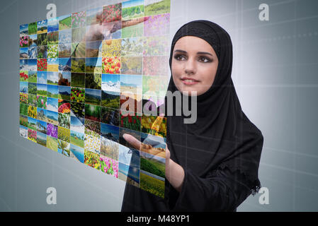 Arabische Frau, die virtuelle Taste auf Natur-collage Stockfoto