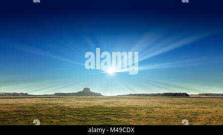 Eine wüste Landschaft mit Sonnenstrahlen in den blauen Himmel Stockfoto